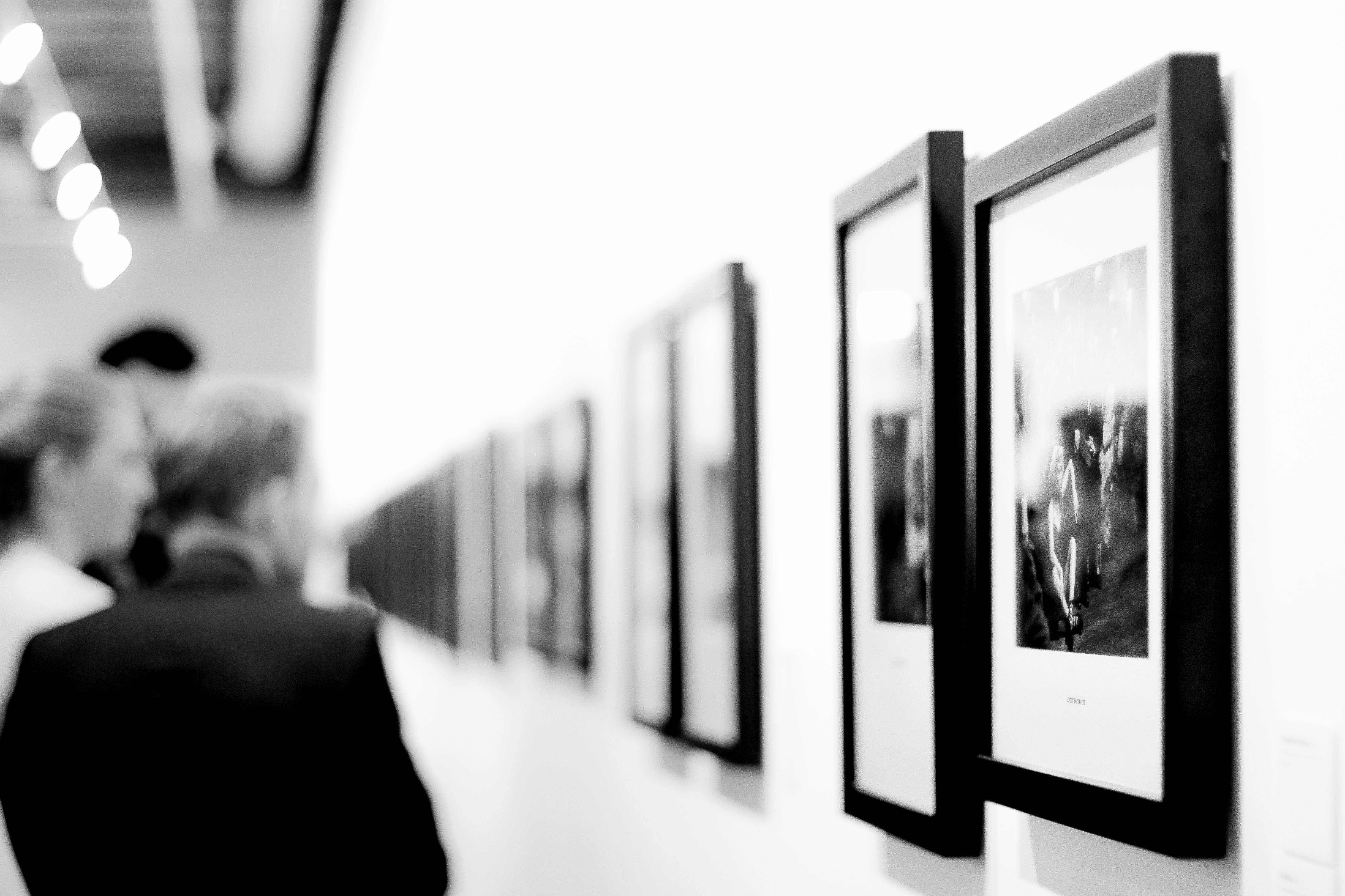 Black and white photo of pictures in an exhibit