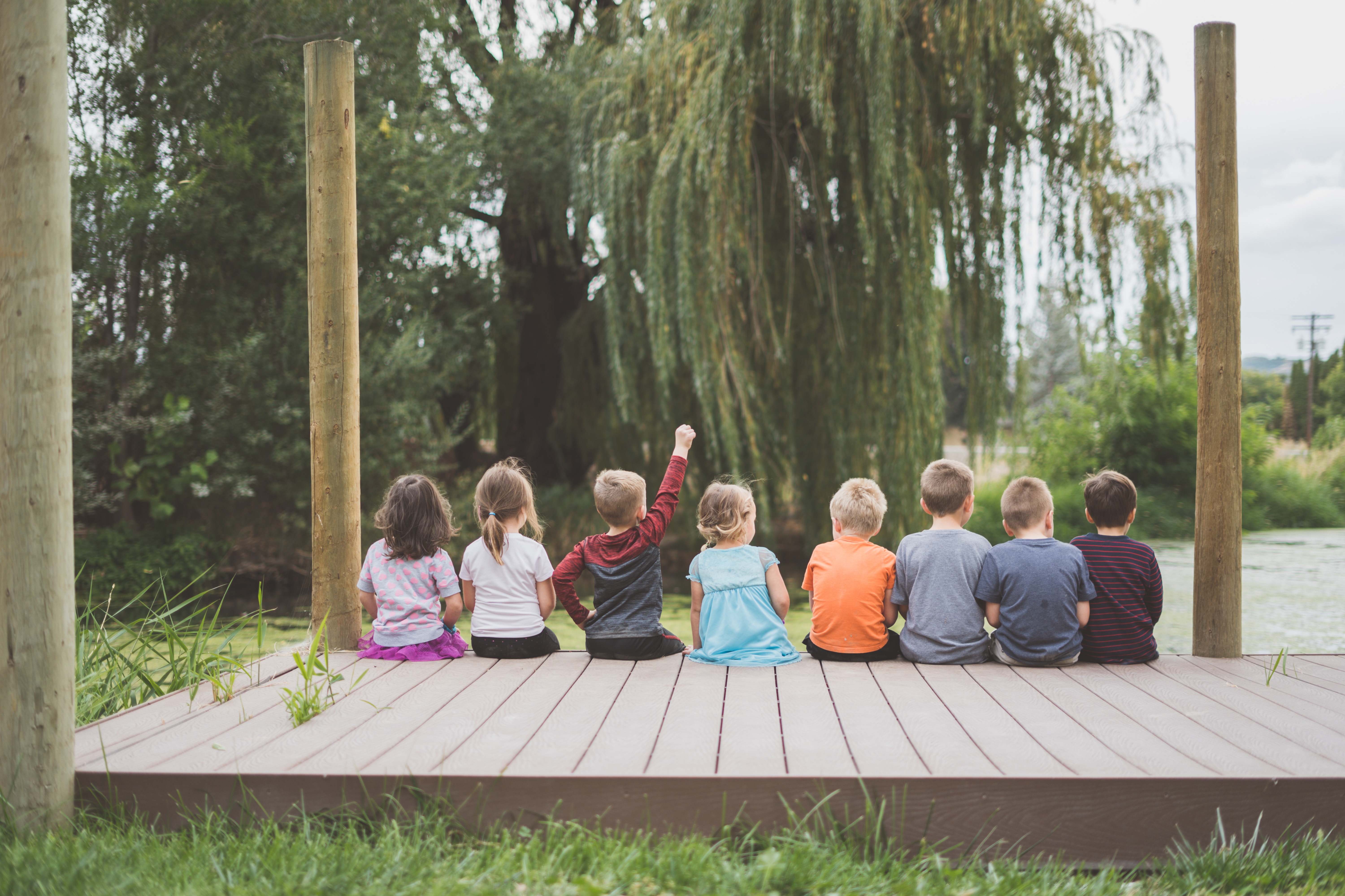 A group of children sitting in a garden