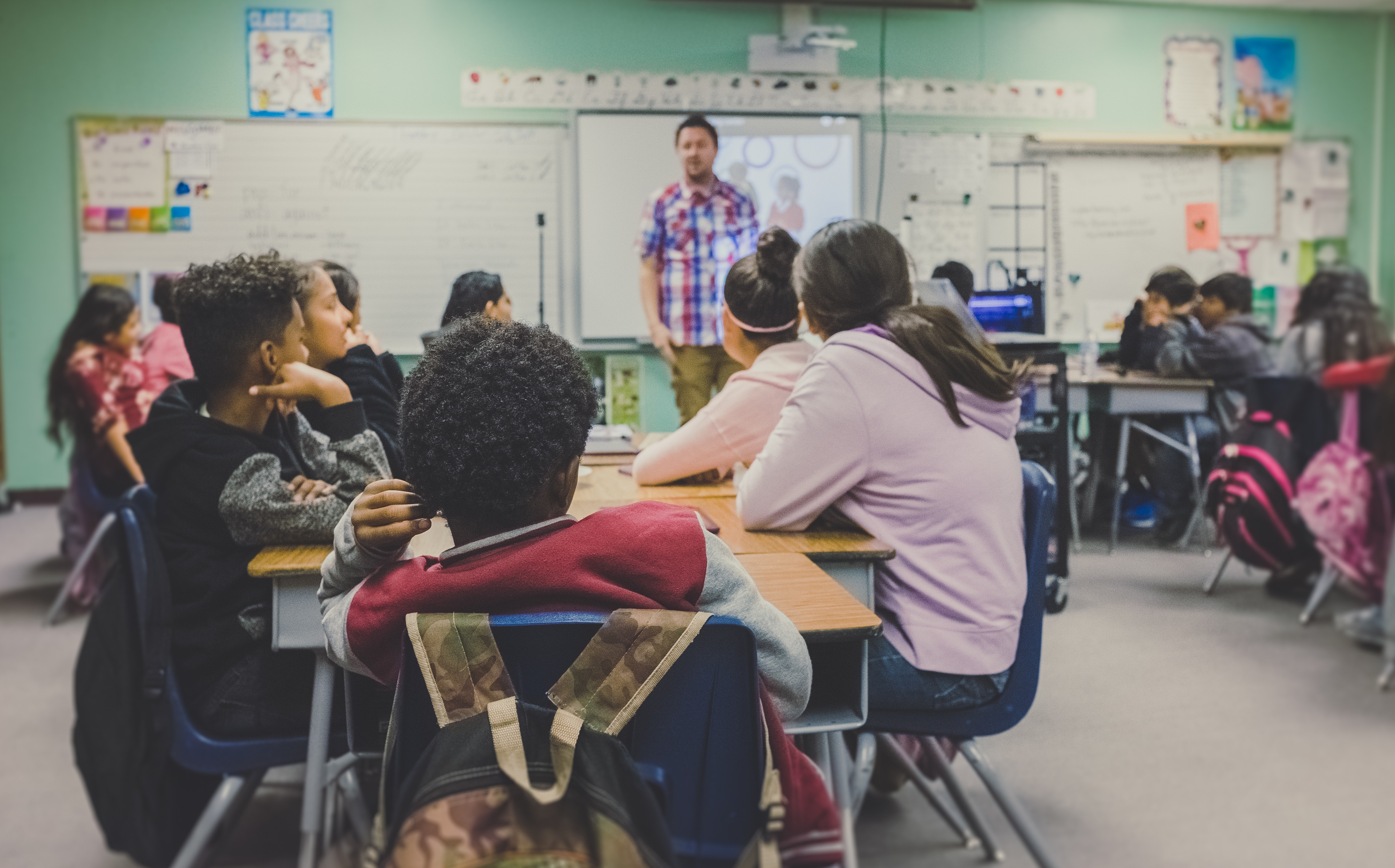 Several students and a teacher in a classroom