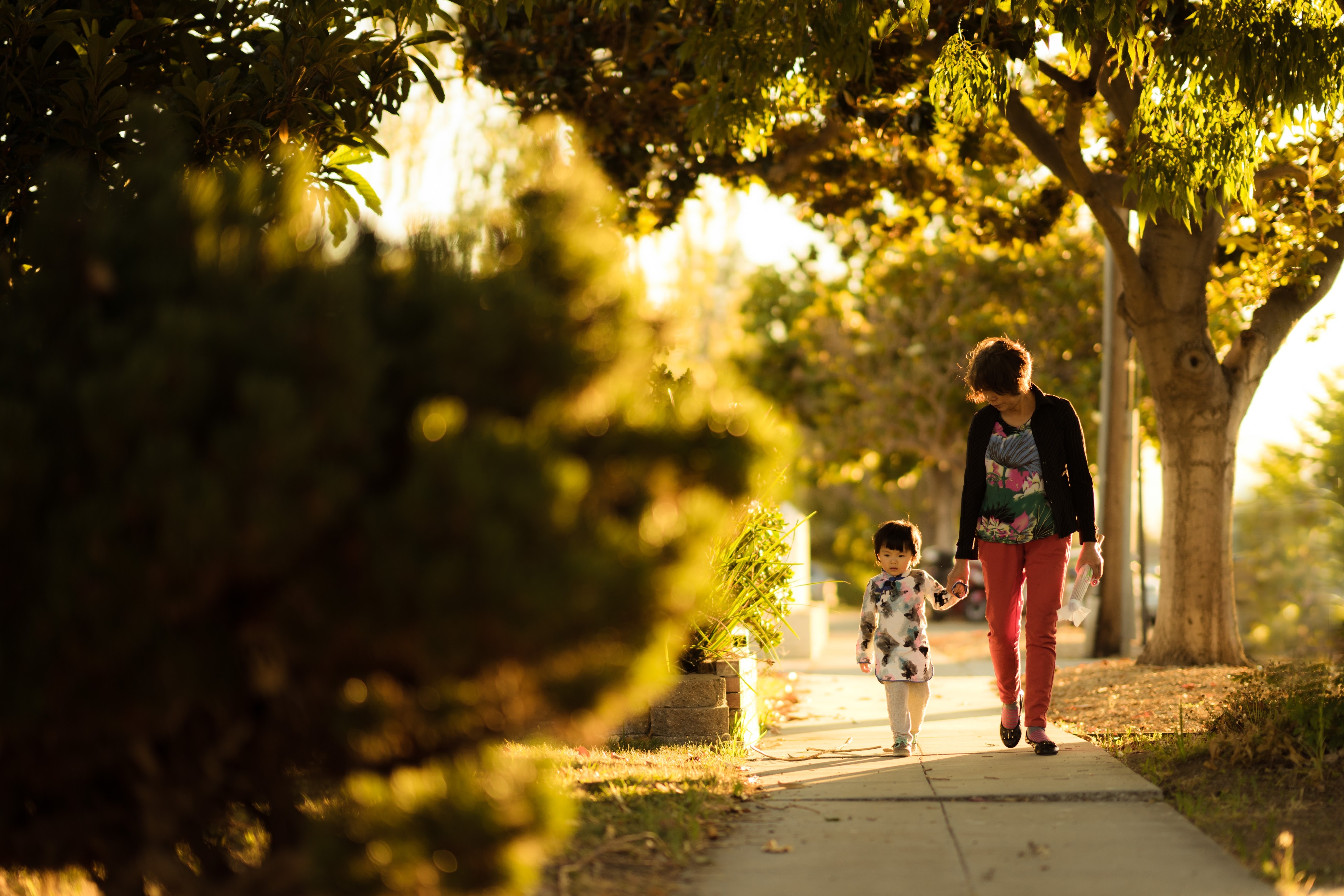 Woman and girl walking in the street