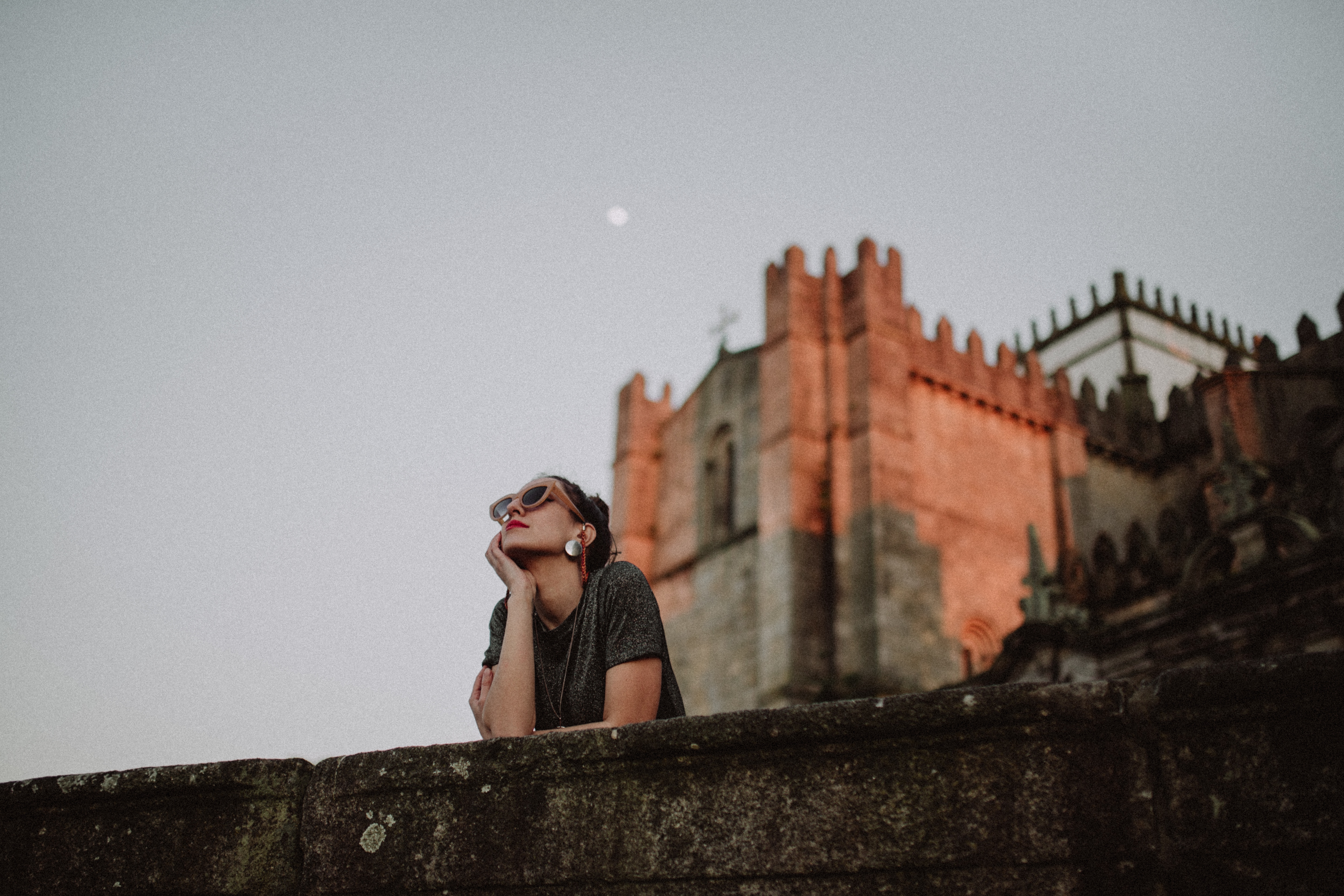 Woman looking at the sky with castle in the background