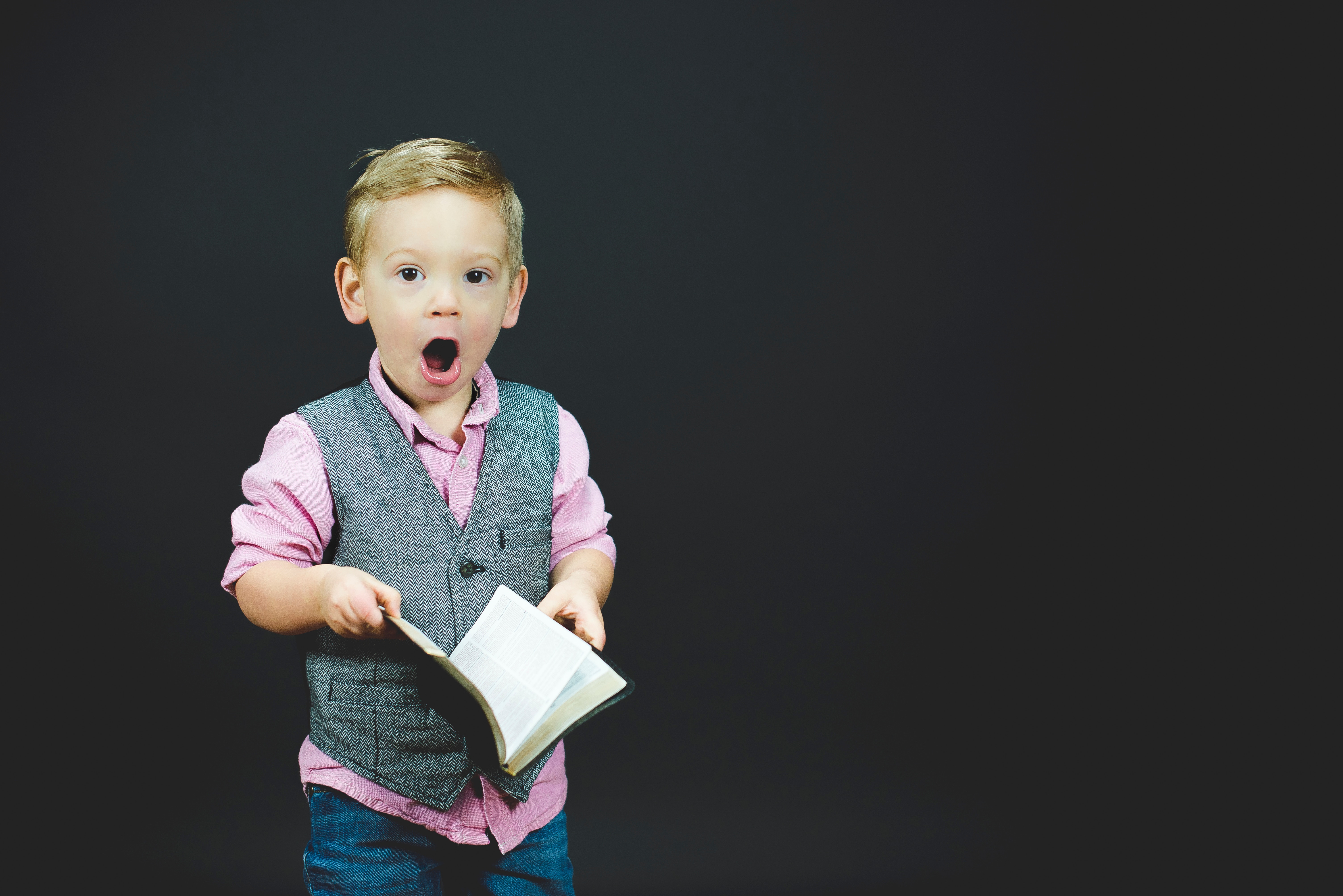 Boy in a vest with open book