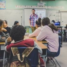 Several students and a teacher in a classroom